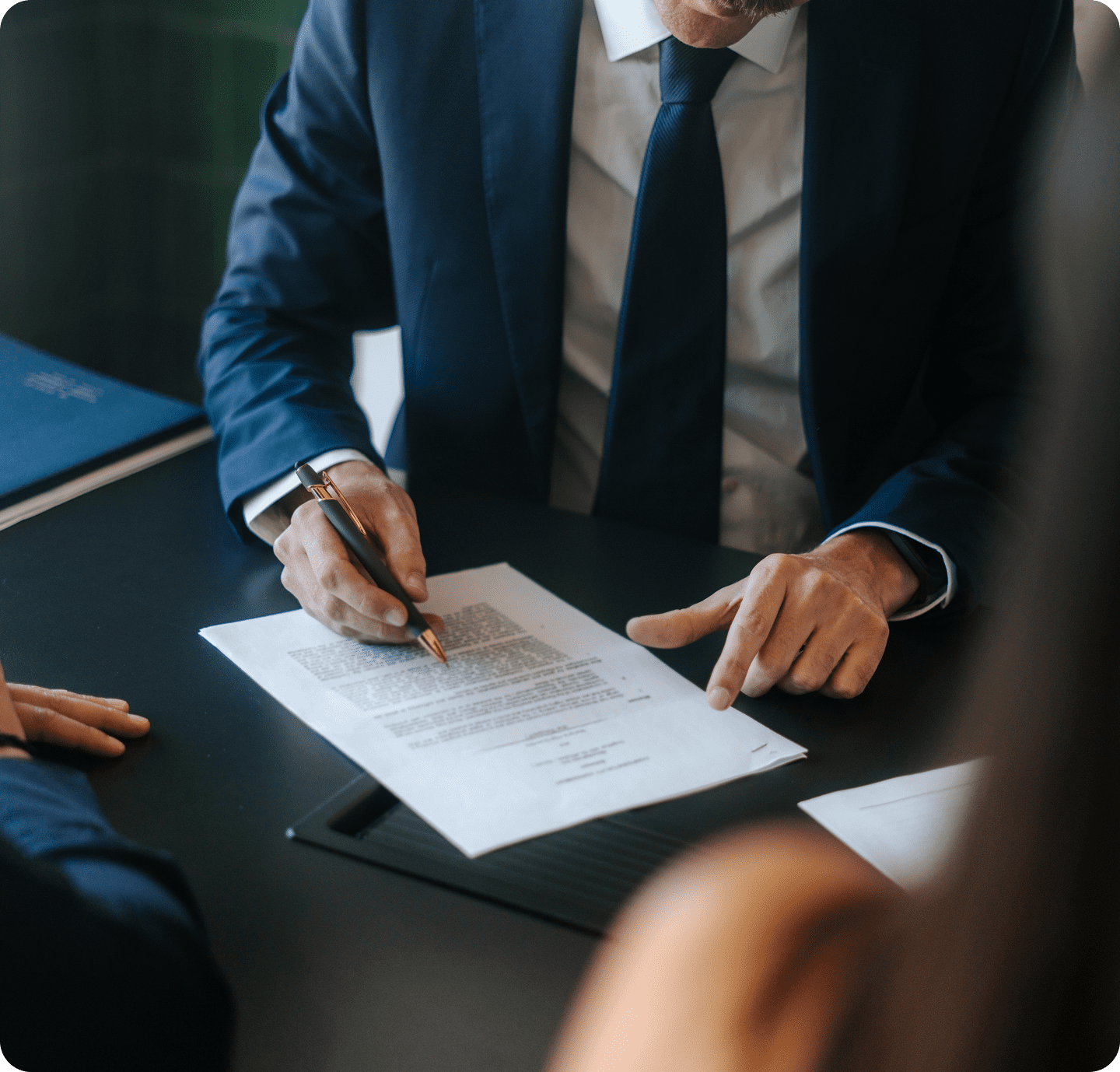 Man in suit reviewing paperwork