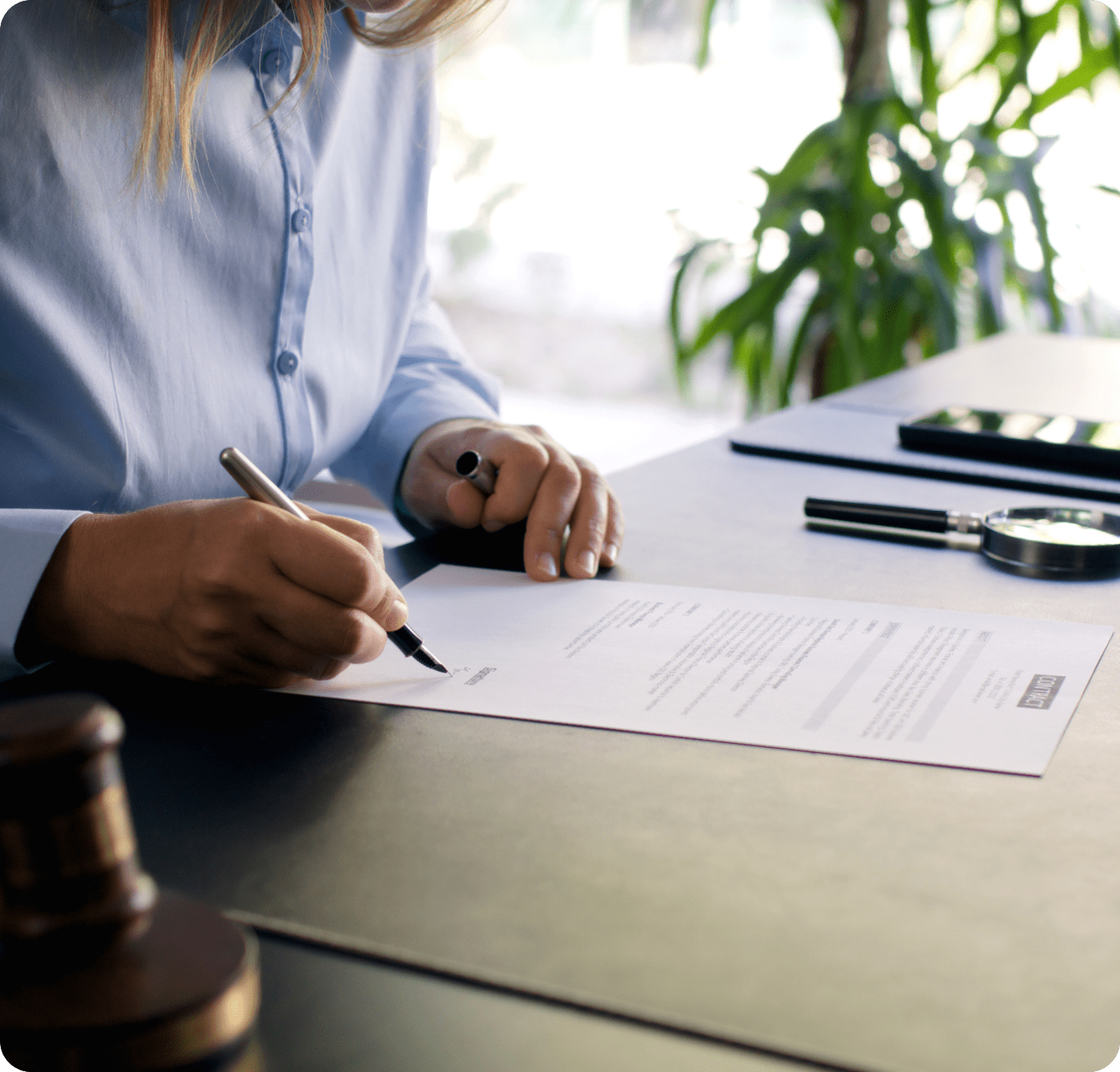 Signing a legal document at desk