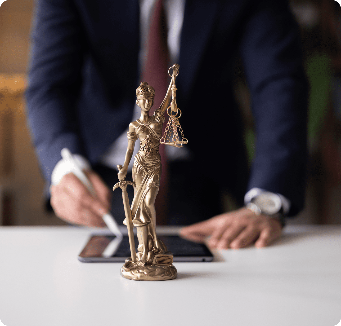 Lady Justice statue with person writing