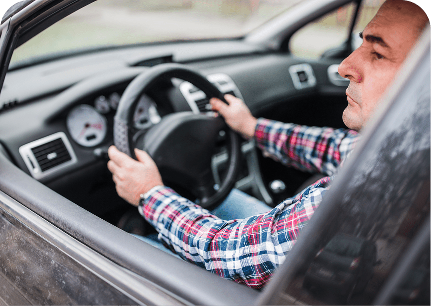 Man driving car with focused expression