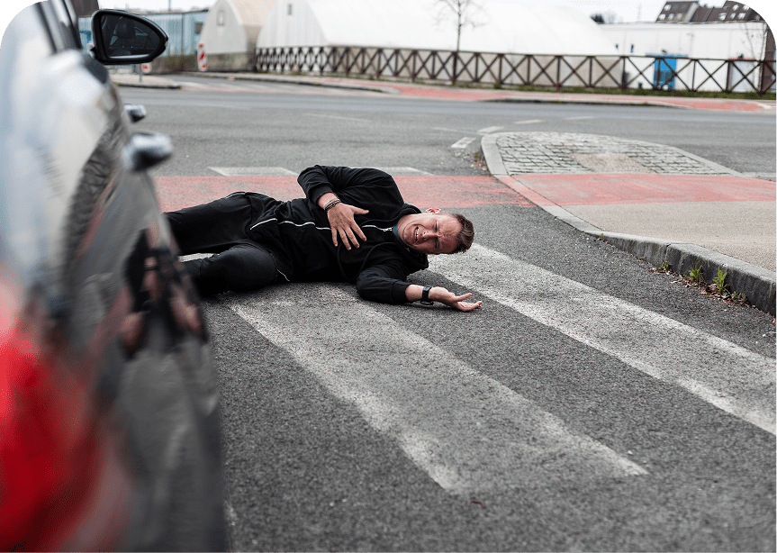 Man lying injured on crosswalk