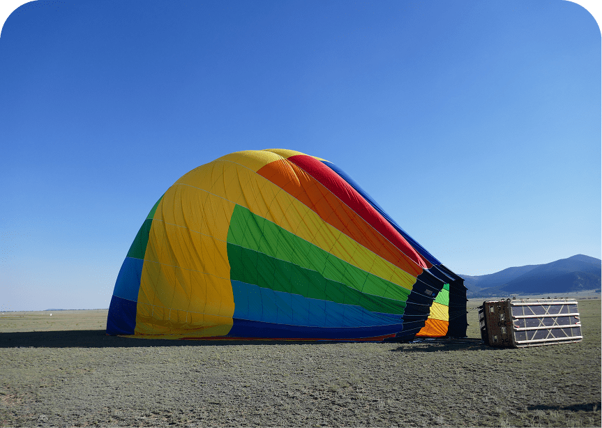 Rainbow hot air balloon preparing for flight