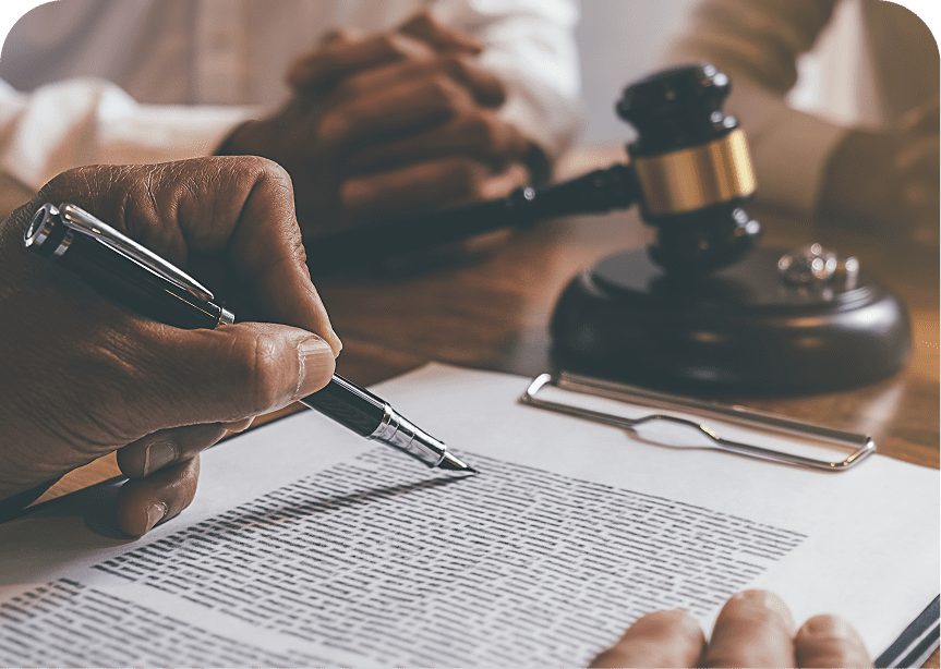 Signing legal documents with gavel nearby