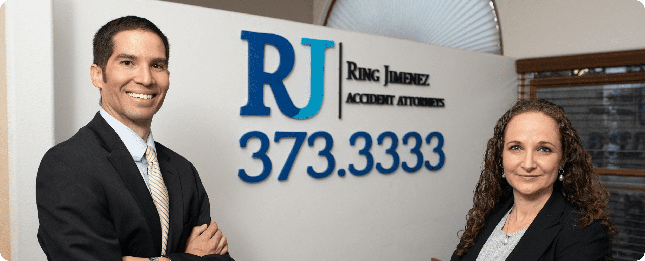 Lawyers posing by office sign