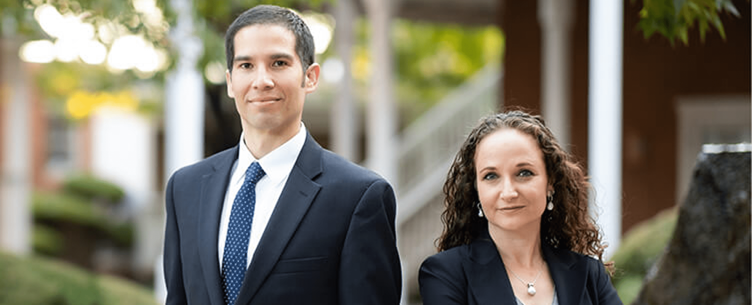 Confident duo standing in garden area