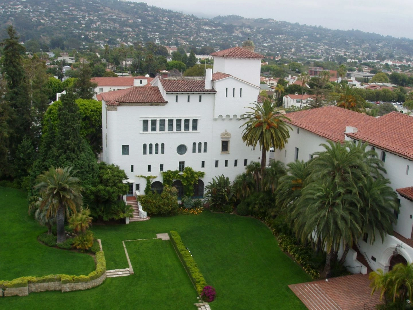 White Spanish-style mansion with red tile roofs