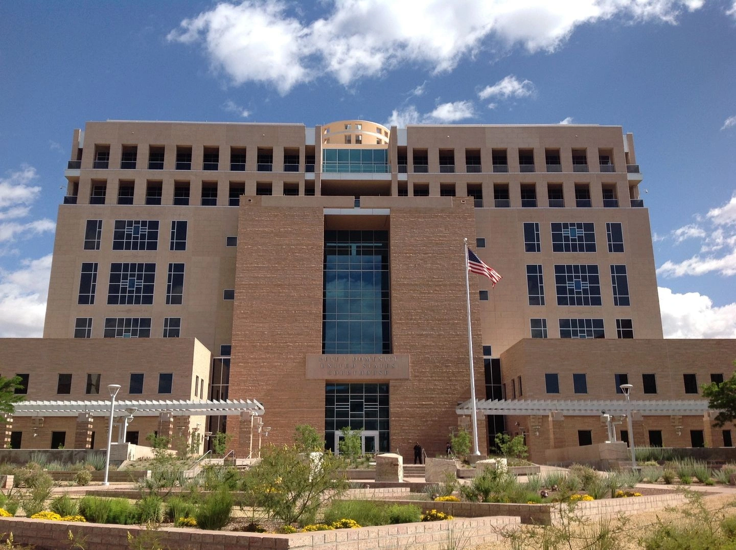 Tan brick government building with American flag