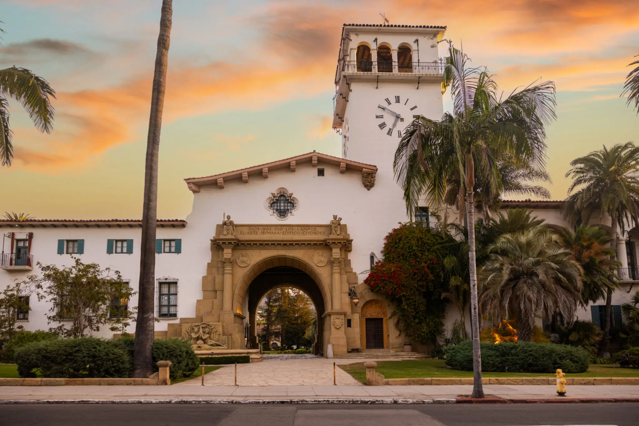 Historic Spanish Colonial clock tower with palm trees