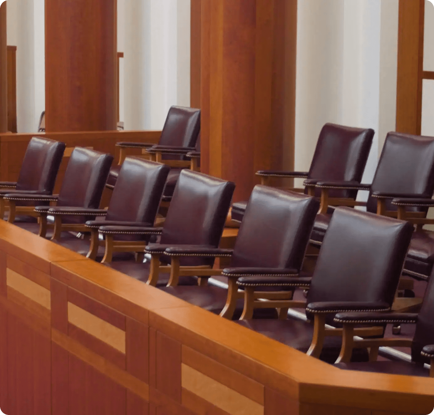 Empty courtroom jury box with leather chairs