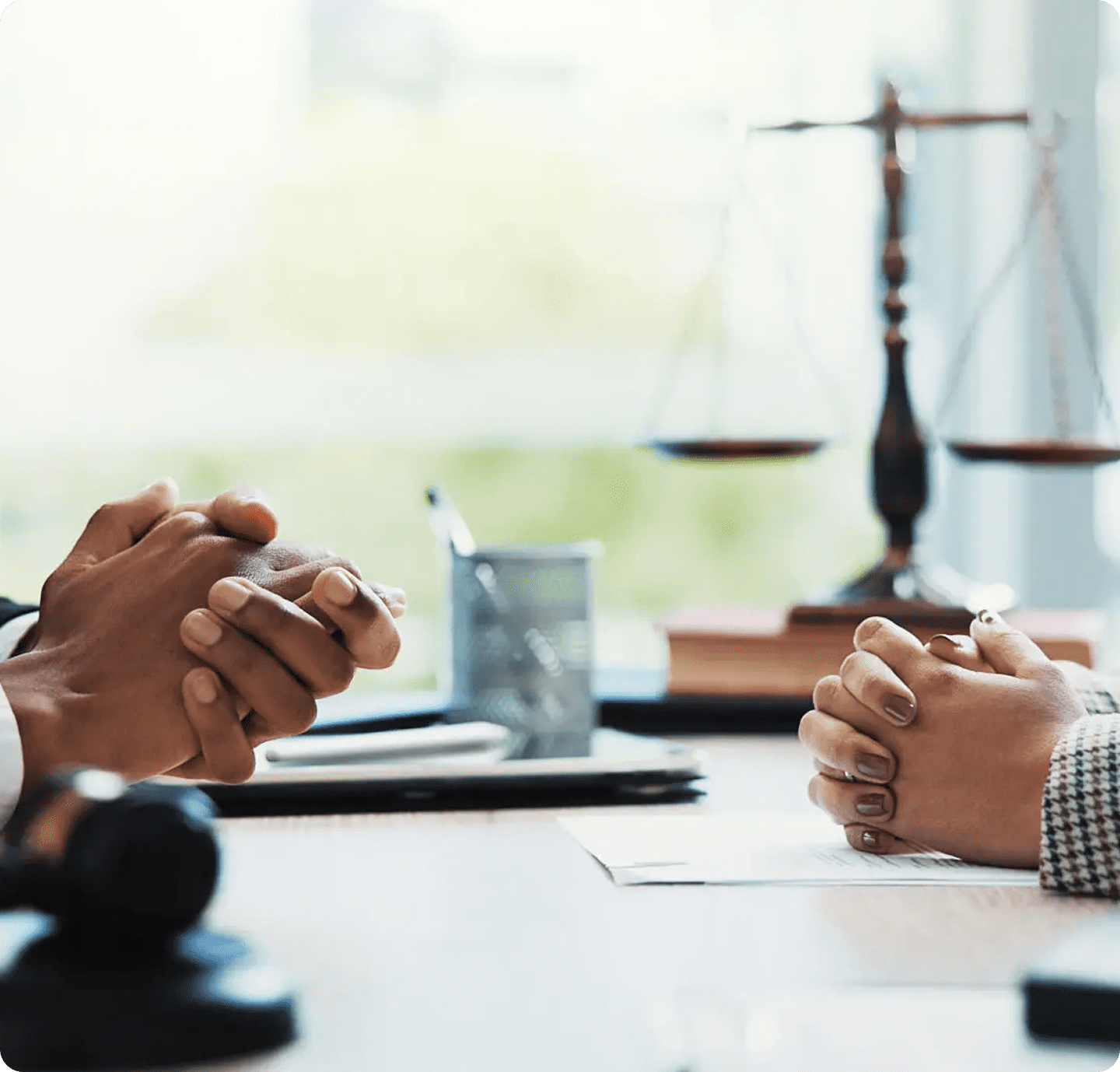 Two people discussing legal matters at desk