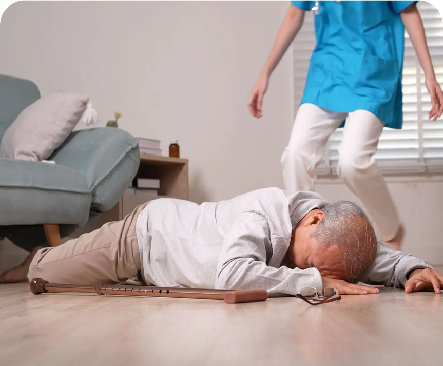 Elderly man fallen on floor, caregiver approaching